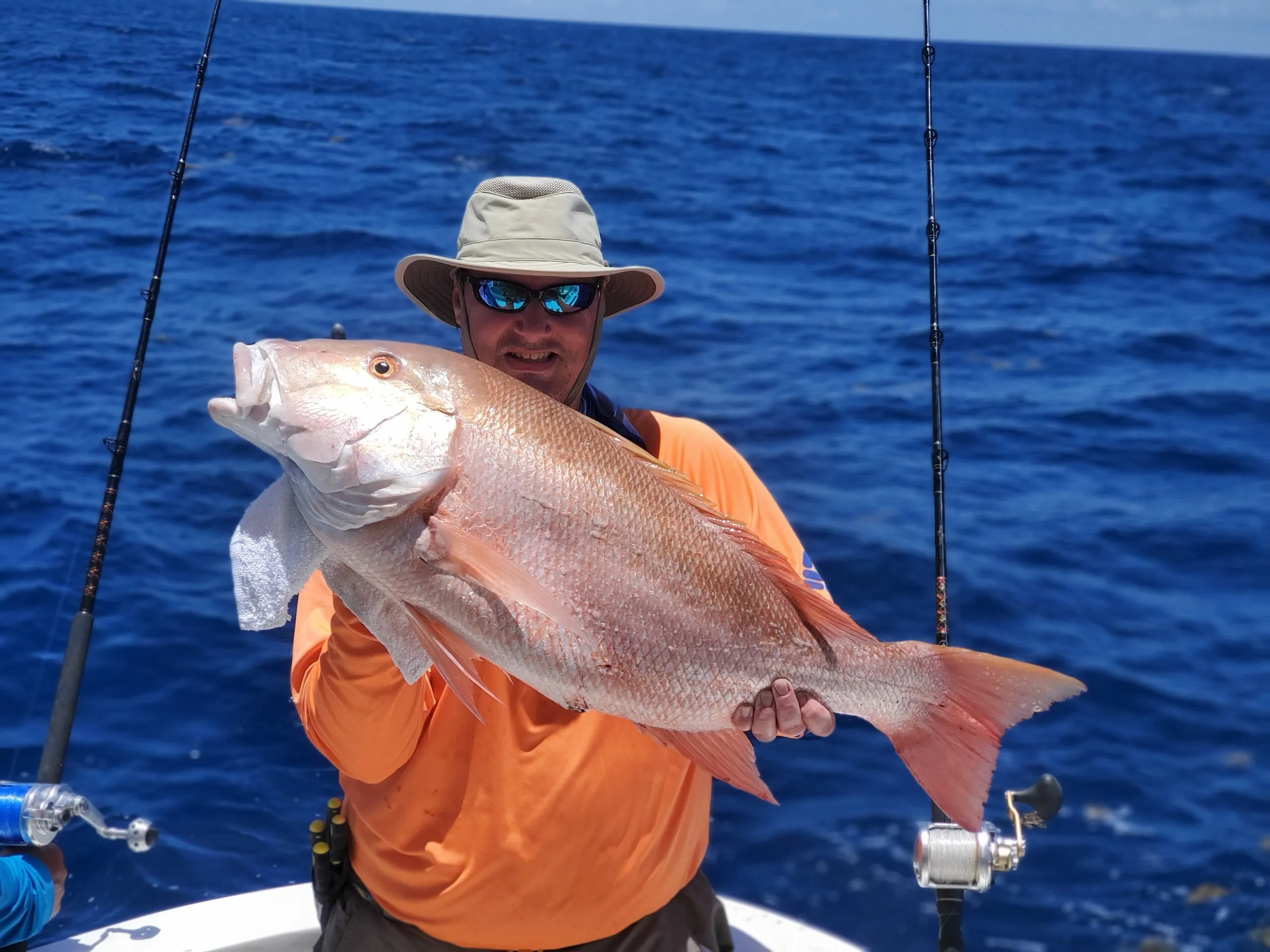 Angler in orange with a snapper