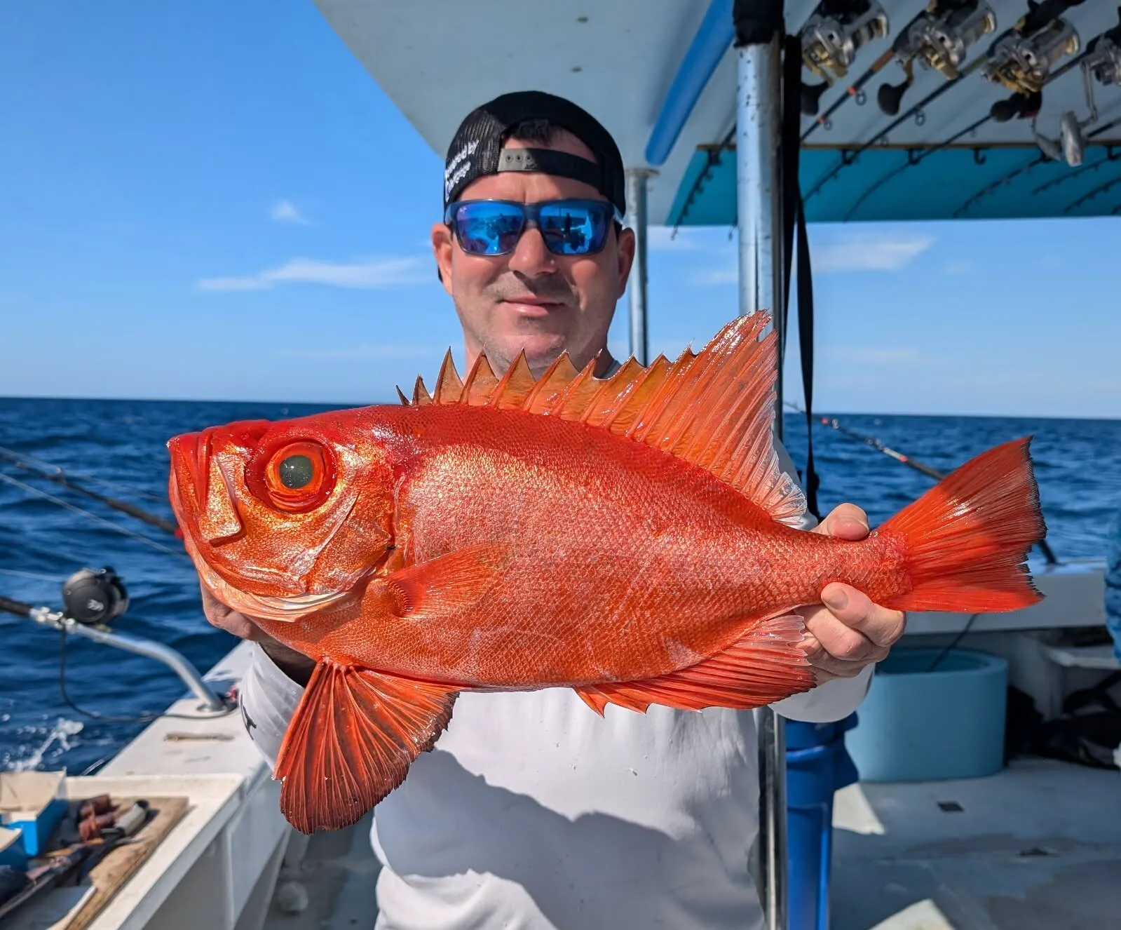 Angler with a big eyed red fish