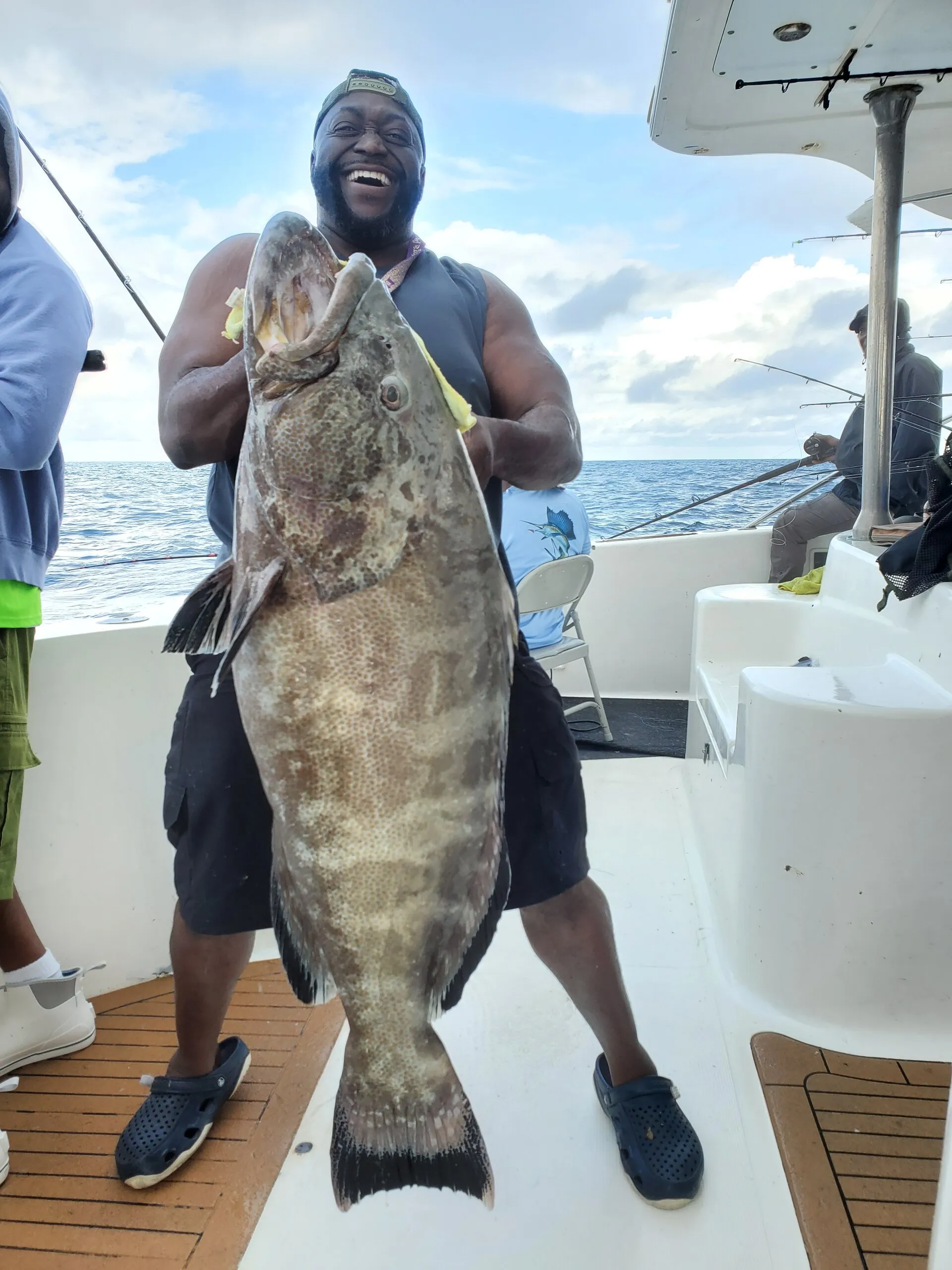 Angler with a black grouper on deck