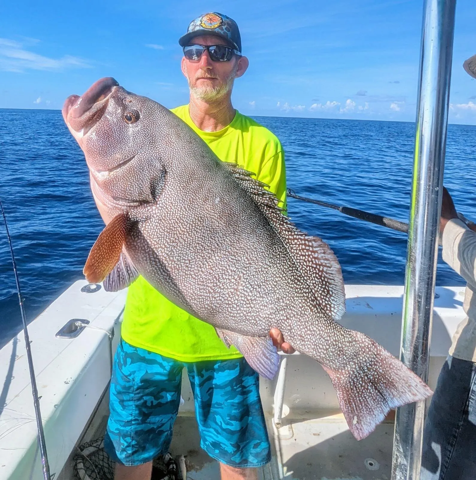 Angler with a speckled grouper