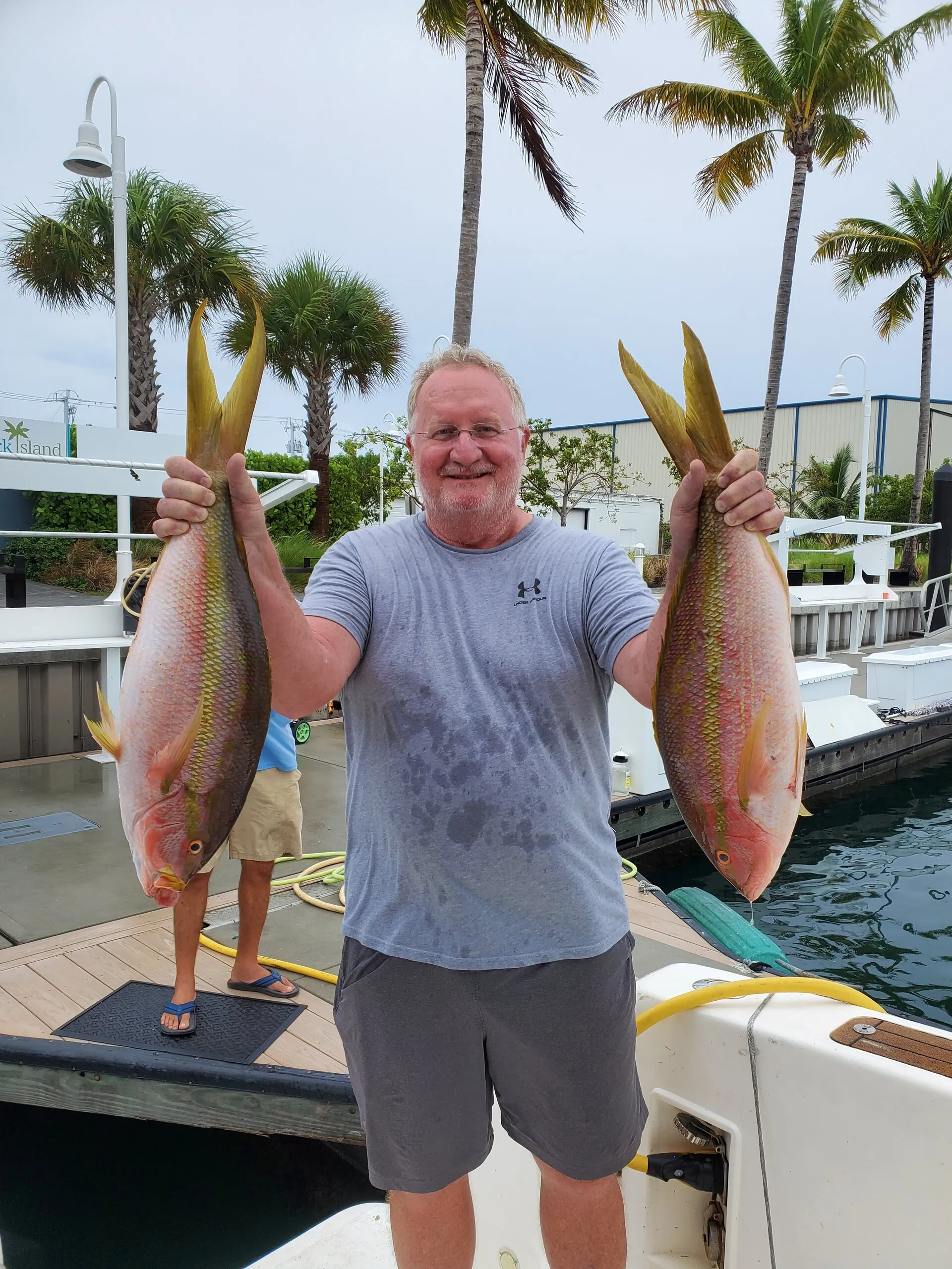 Angler with two yellowtail snapper