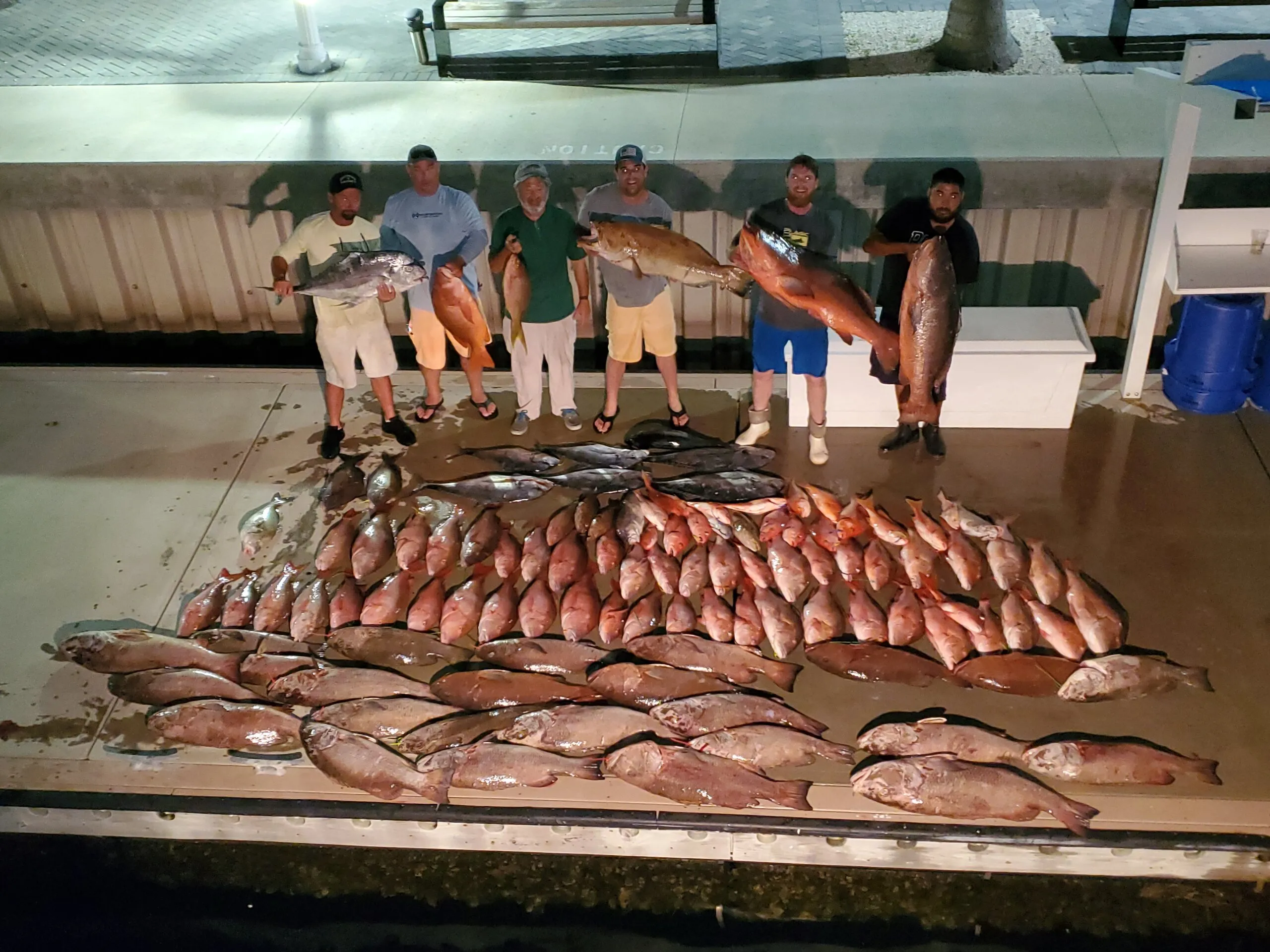 Crew behind a night catch on the dock