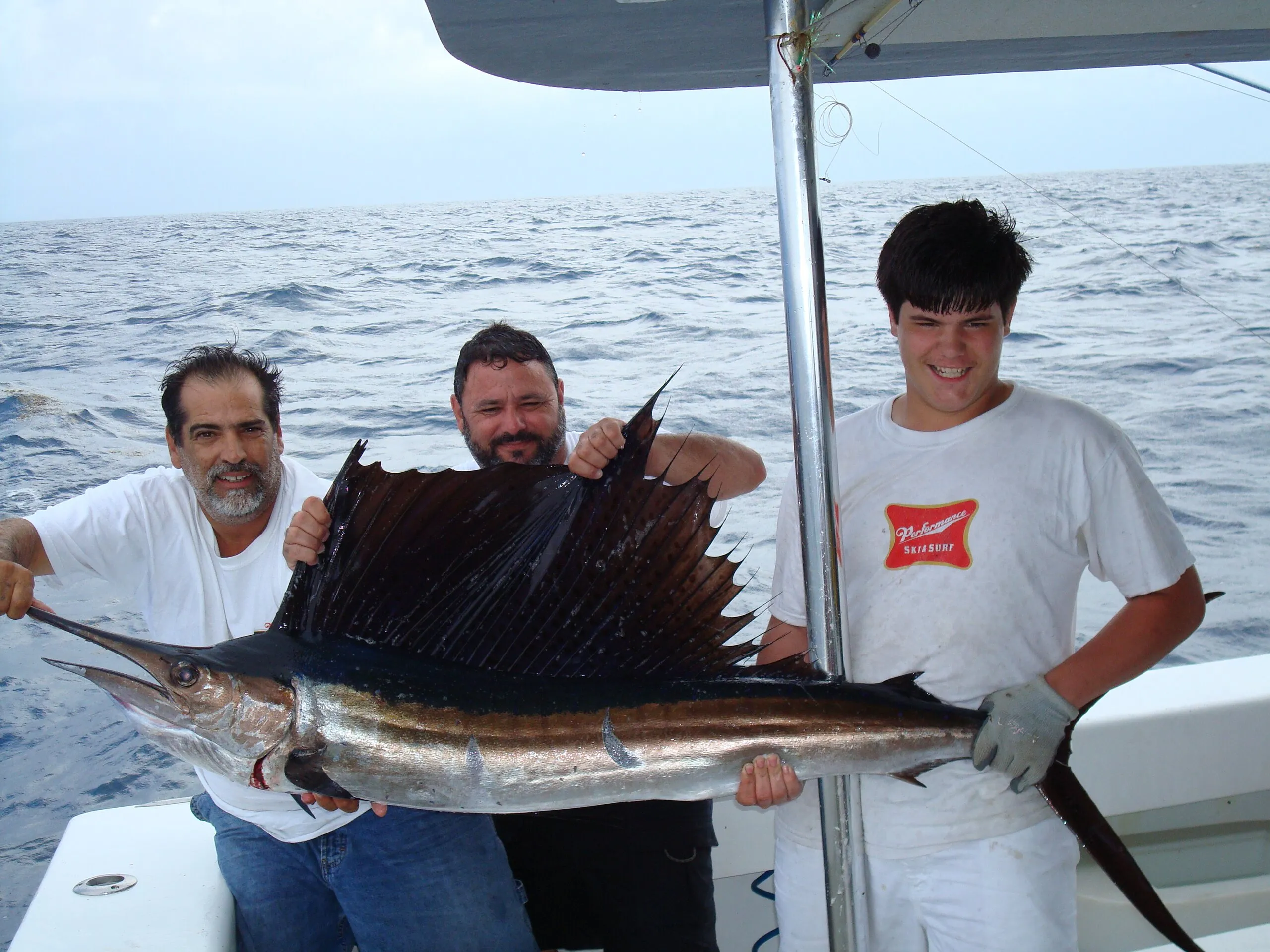 Three anglers with a sailfish