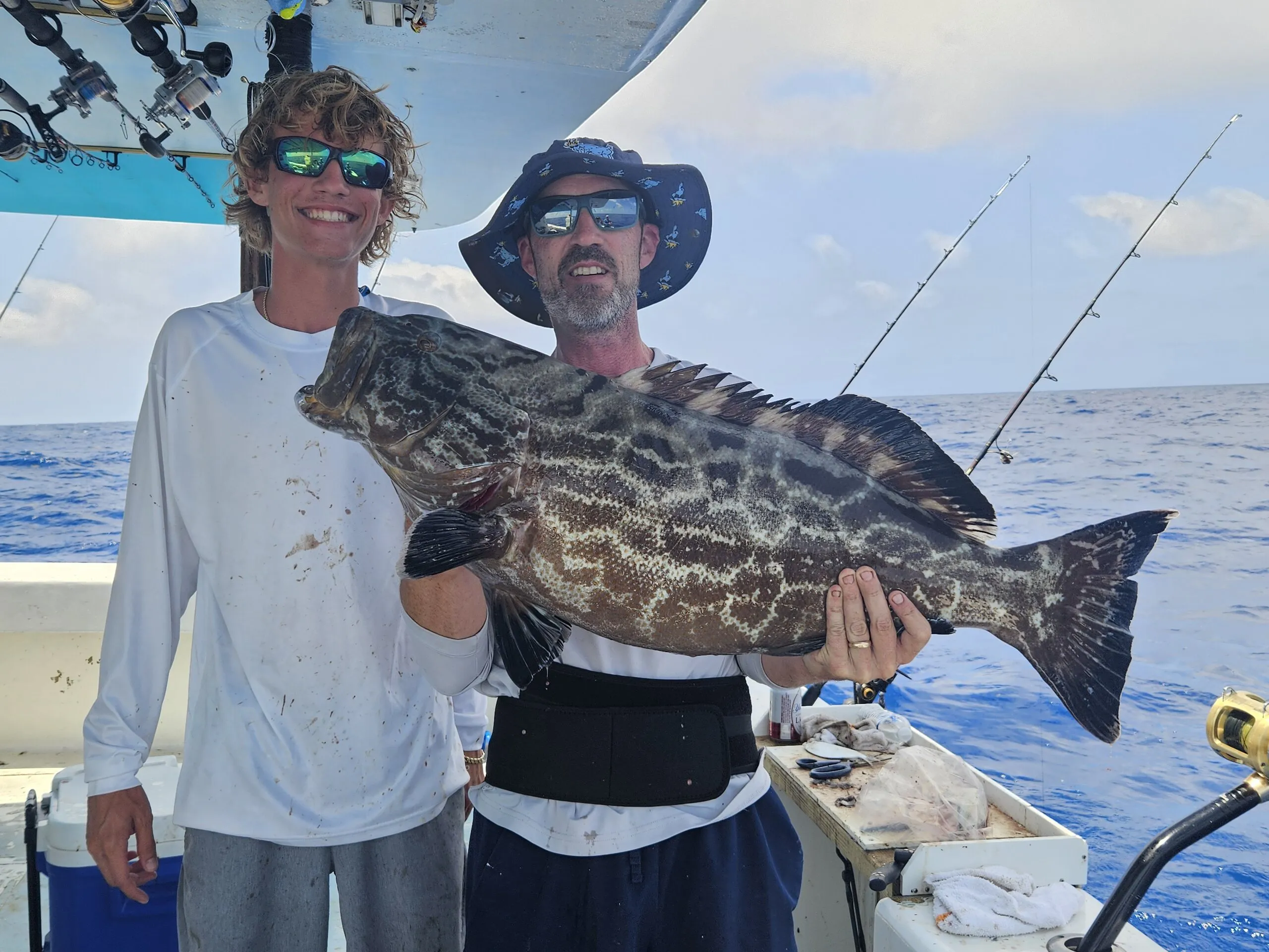 Two anglers with a big black grouper